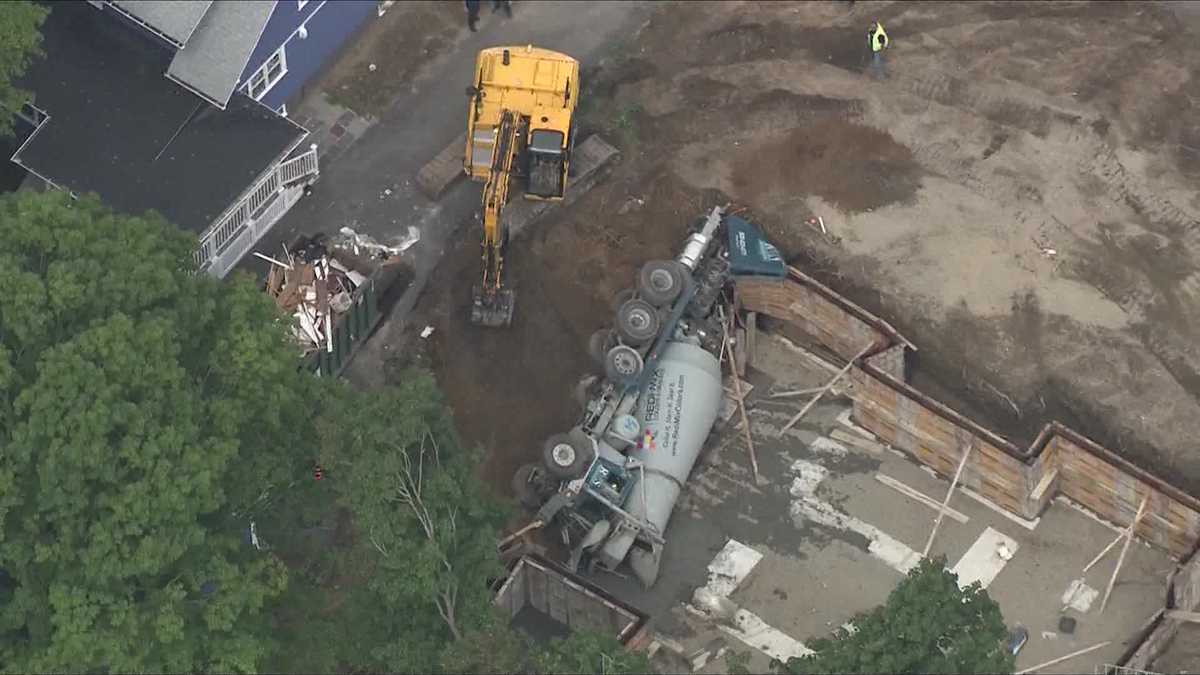 Sky 5: Concrete truck tips, tumbles into foundation hole