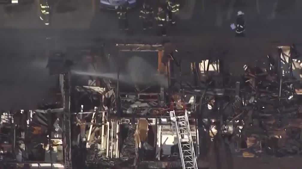 Displaced residents try to salvage belongings after massive apartment fire