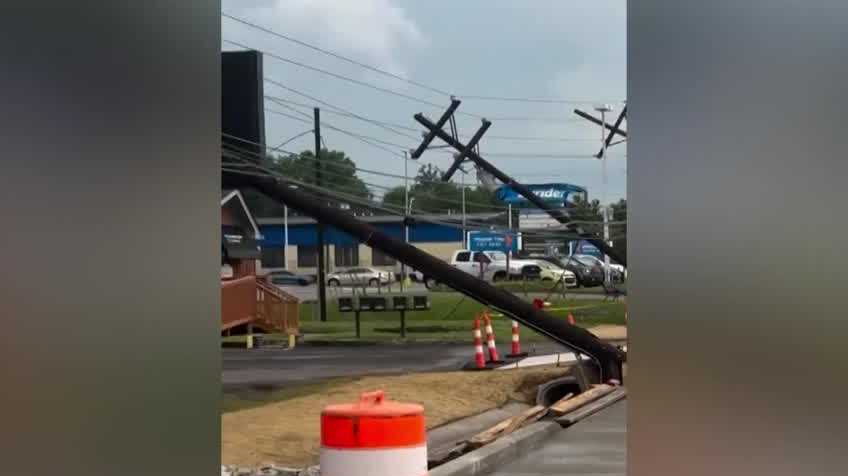 Strong storms blow over power poles on Preston Highway