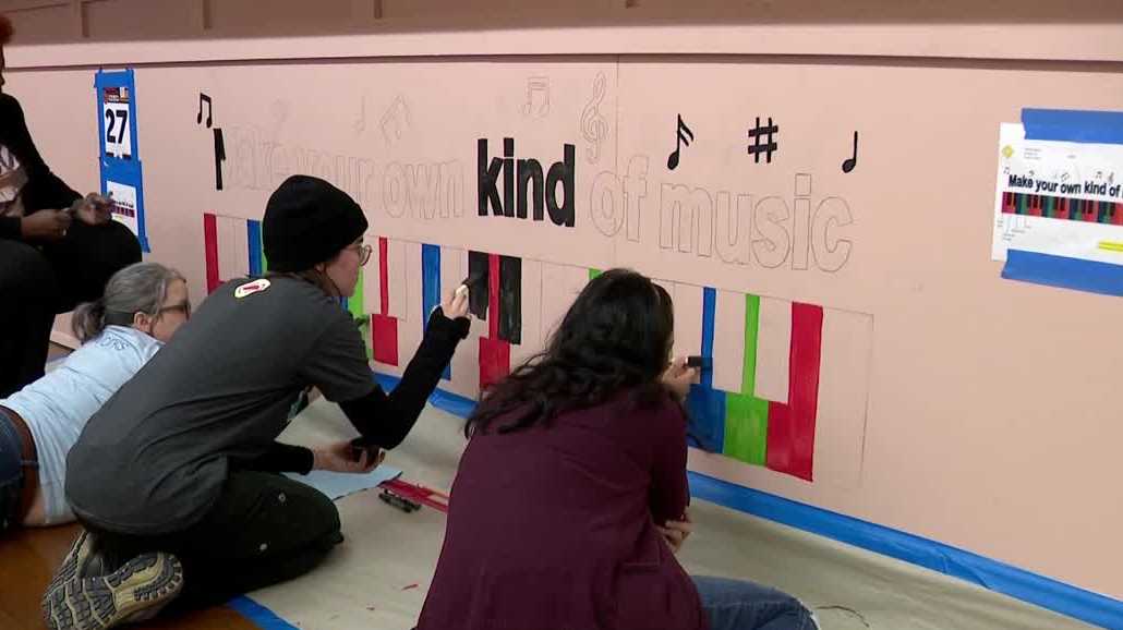 Milwaukee volunteers paint murals at school on MLK Day