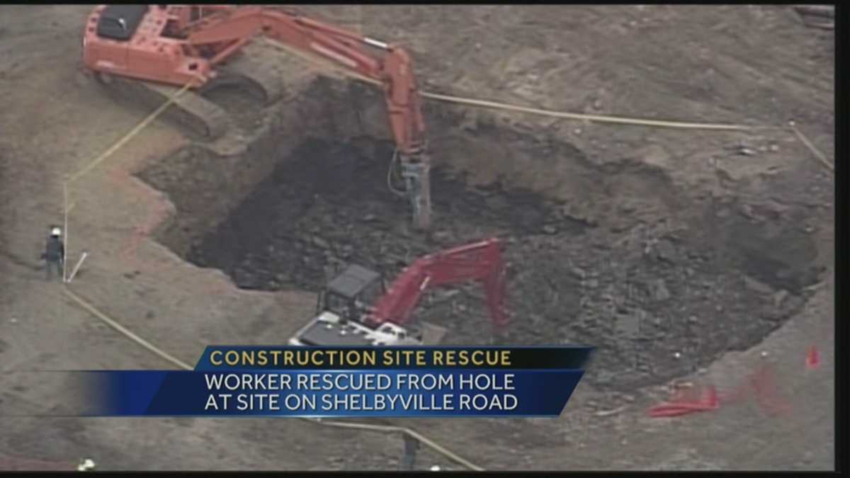 Worker rescued after falling into hole at work site