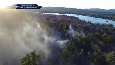 Drone video shows brush fire burning in Milton