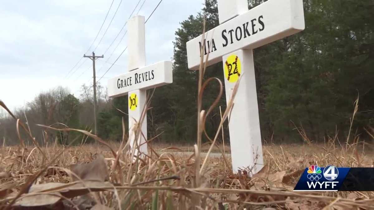 Family places crosses to remember two college students killed in crash