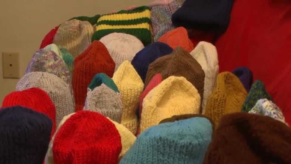 Woman donates hundreds of knitted hats, gloves and blankets