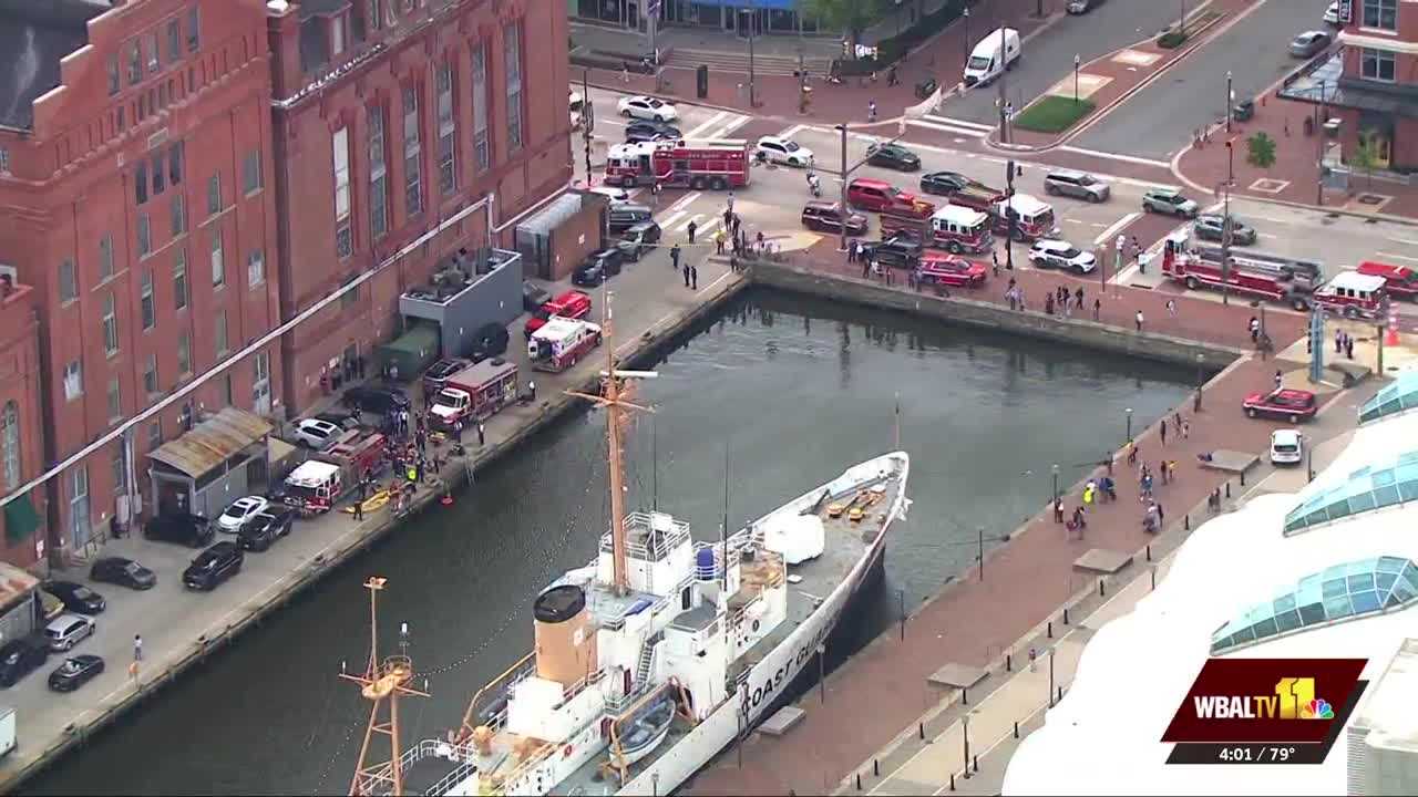 Divers pull man from water behind Power Plant Live