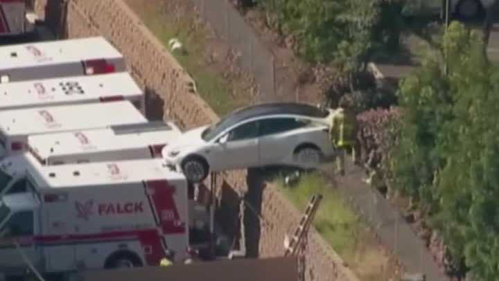 Car crashes down embankment into ambulance in San Diego