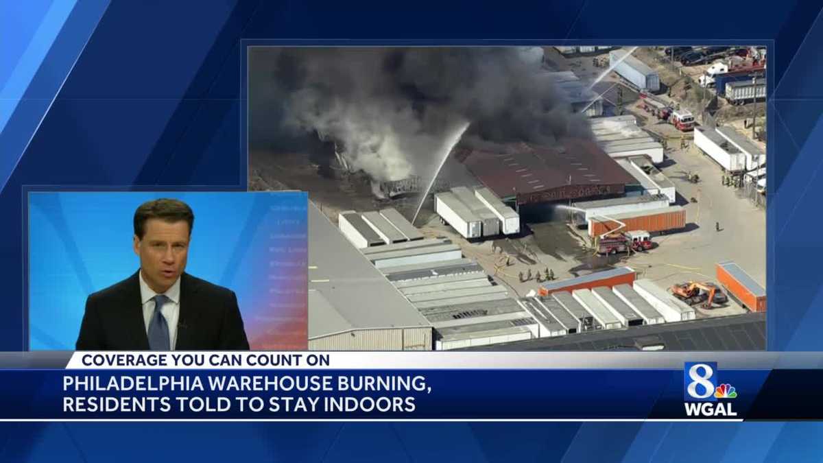 Large fire billows smoke as it consumes Philadelphia warehouse