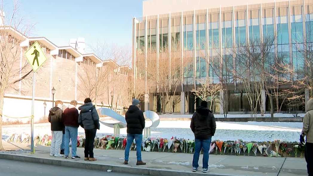 Students, staff and community members visit memorial site at Brown University to mourn victims