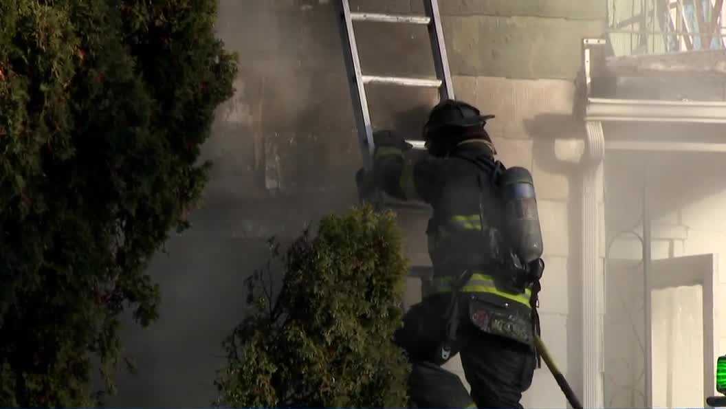 Milwaukee firefighters battle house fire in freezing conditions