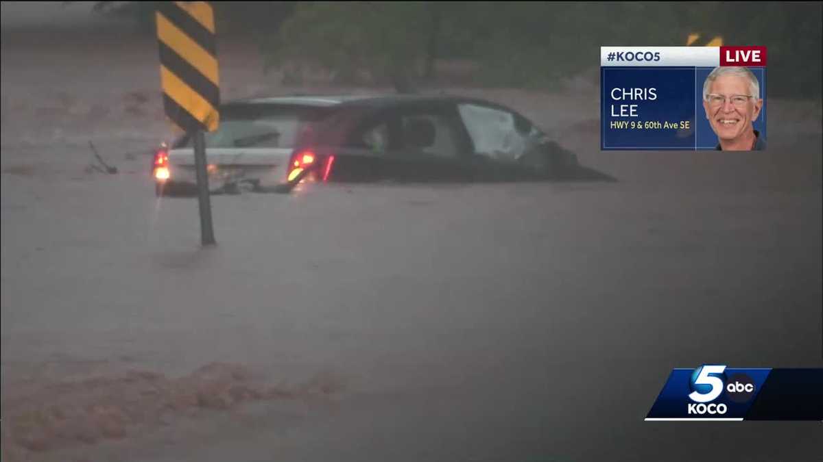 Vehicle submerged in water after flooding in Norman