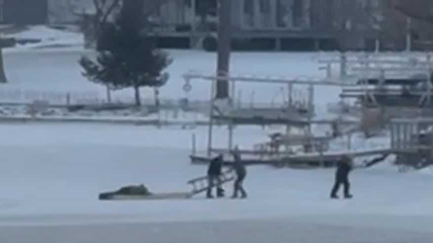 WATCH: Neighbor with a paddleboard helps rescue man who fell in while ice fishing