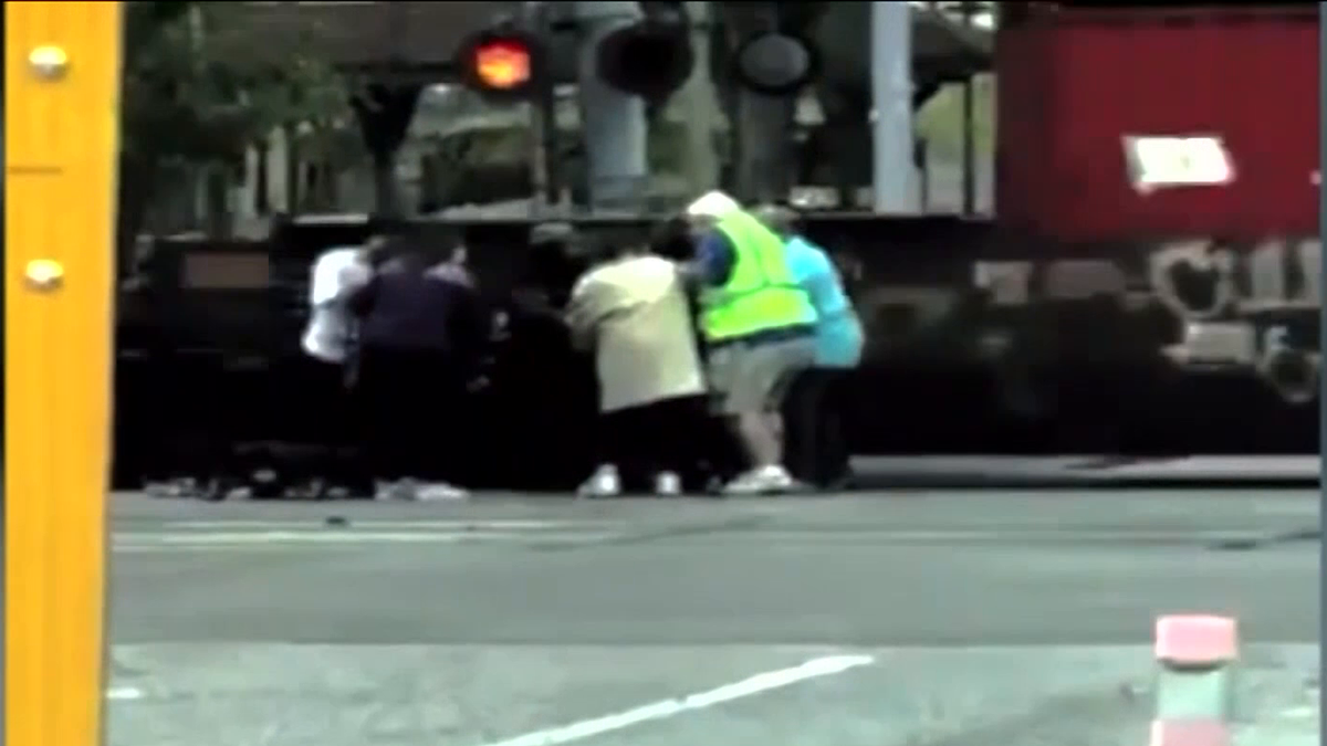 Bystanders Help Save Man After His Wheelchair Gets Stuck On Train Tracks