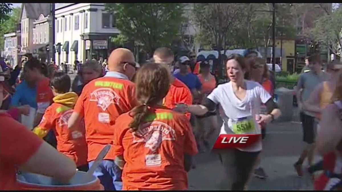 Runners make water stop during marathon
