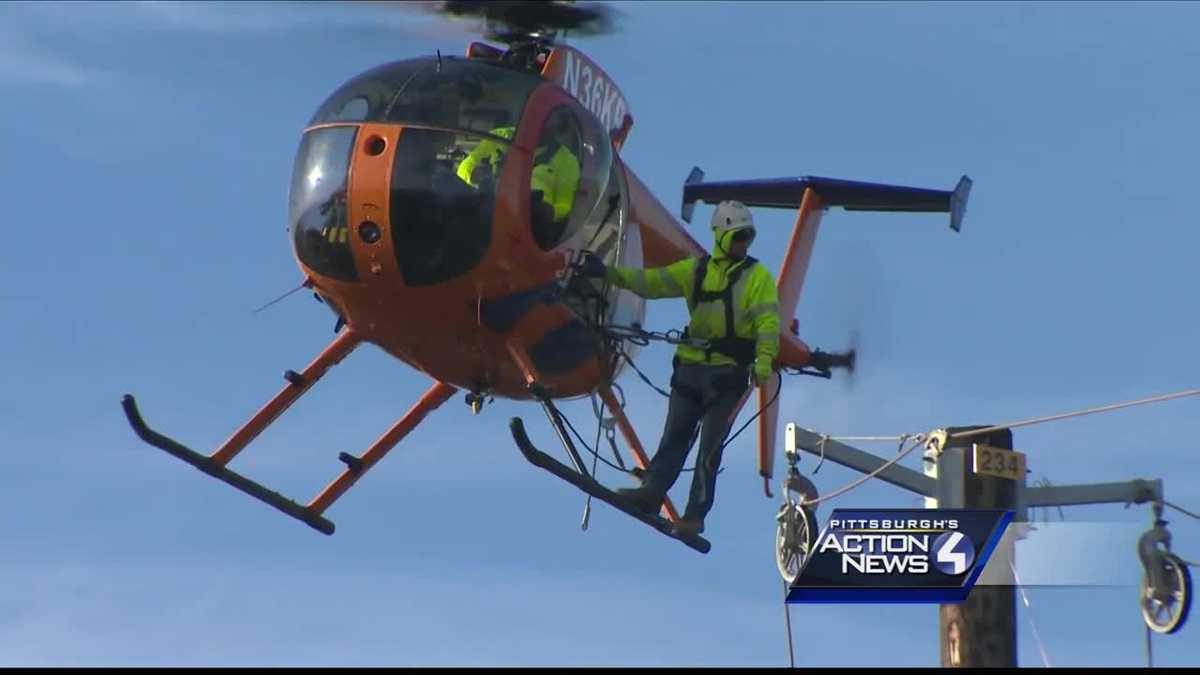 First Energy workers use helicopters to build modern power lines