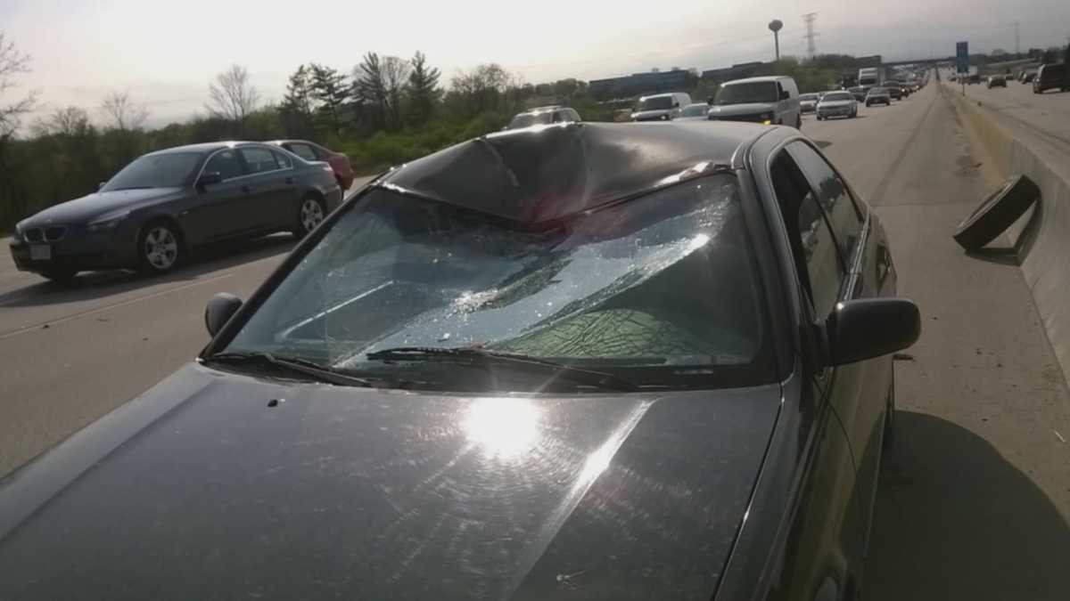 Tire smashes through windshield of vehicle on highway