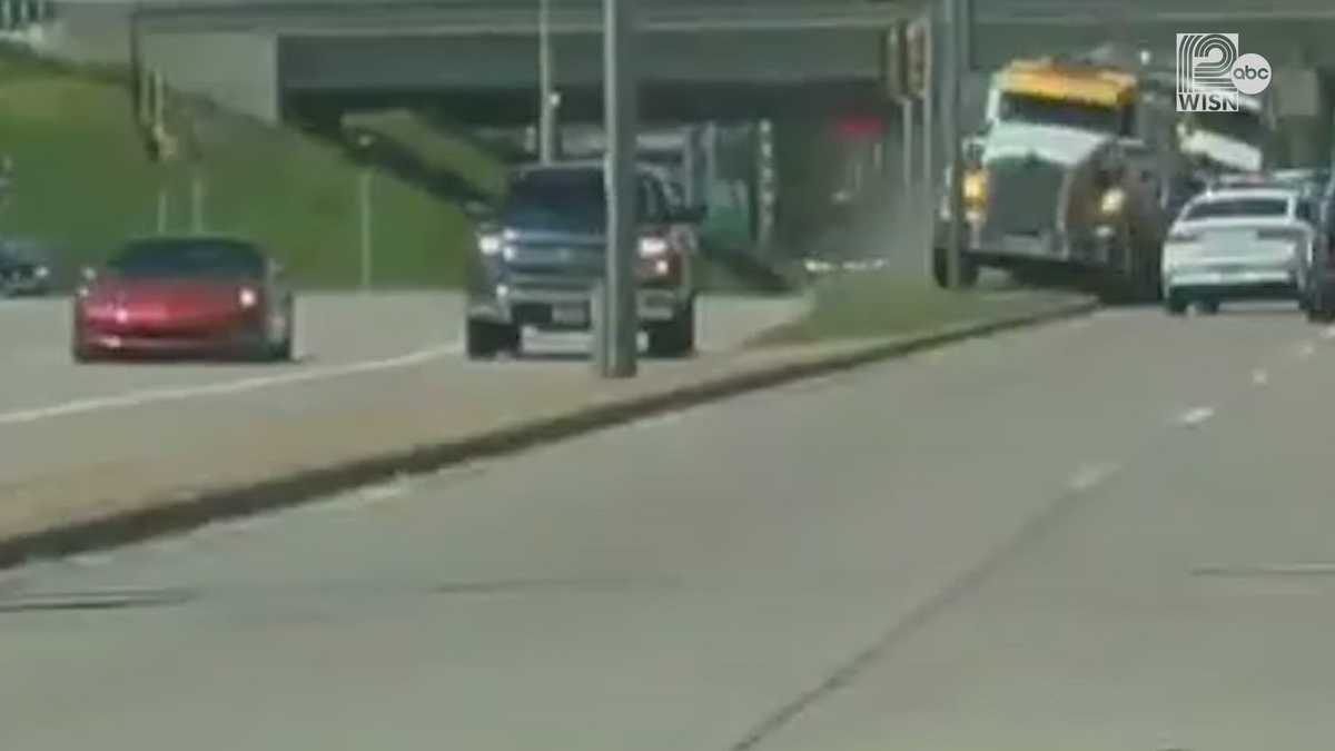 Camera captures dump truck roll over onto car in Appleton; 1 dead
