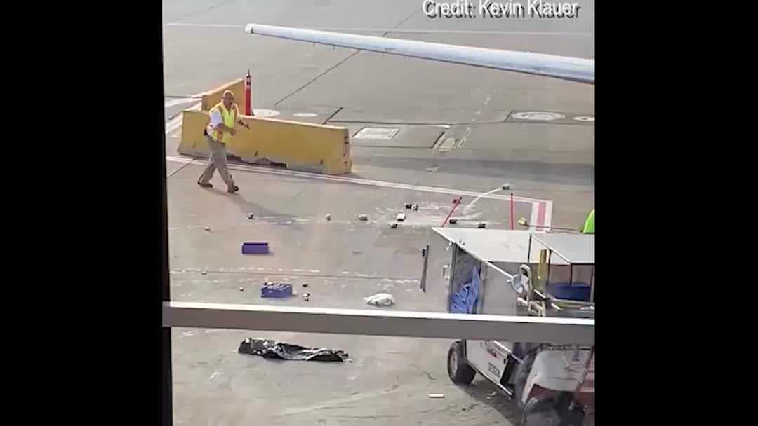 WHOA Catering cart spins out of control near plane at airport, video shows