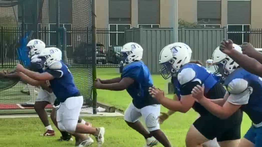 Saints surprise Patrick F. Taylor football team with new helmets