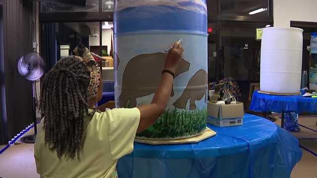 Seniors in Lehigh Acres paint rain barrels to conserve water and help with bills