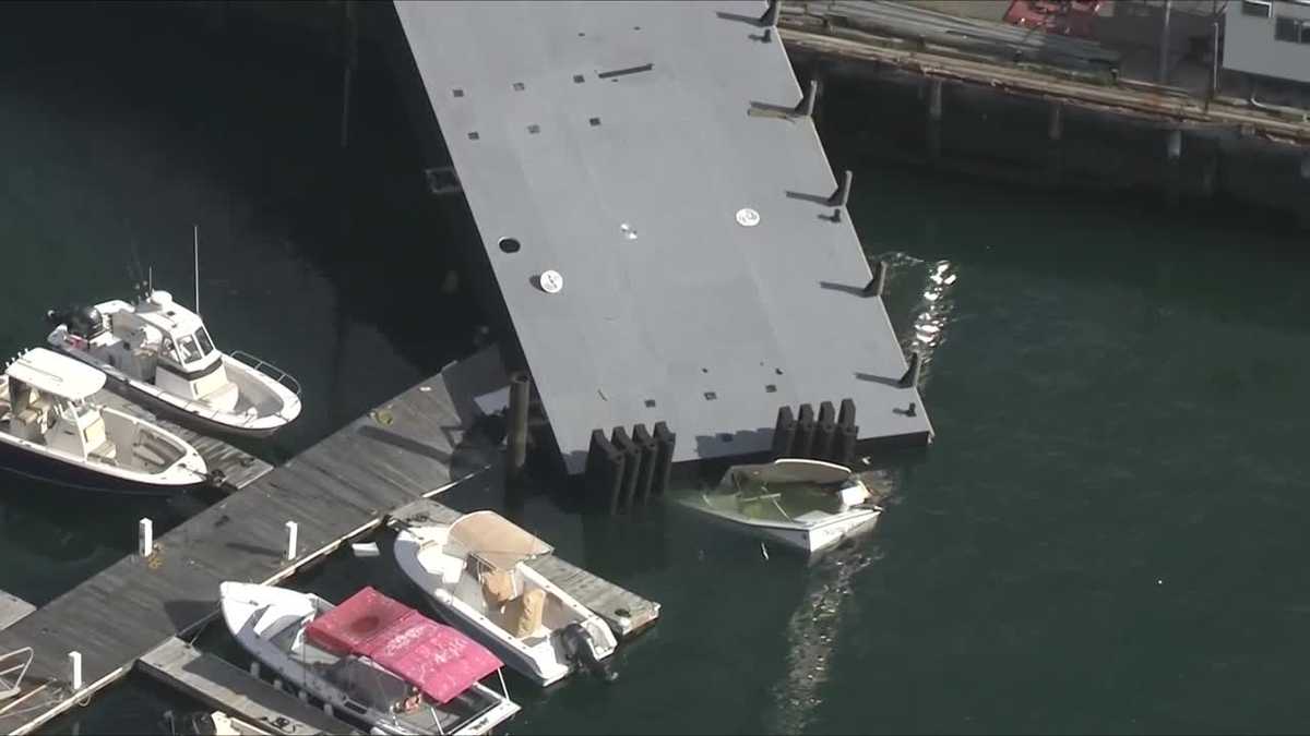Crane straps give way, sending floating pier crashing onto boat, marina