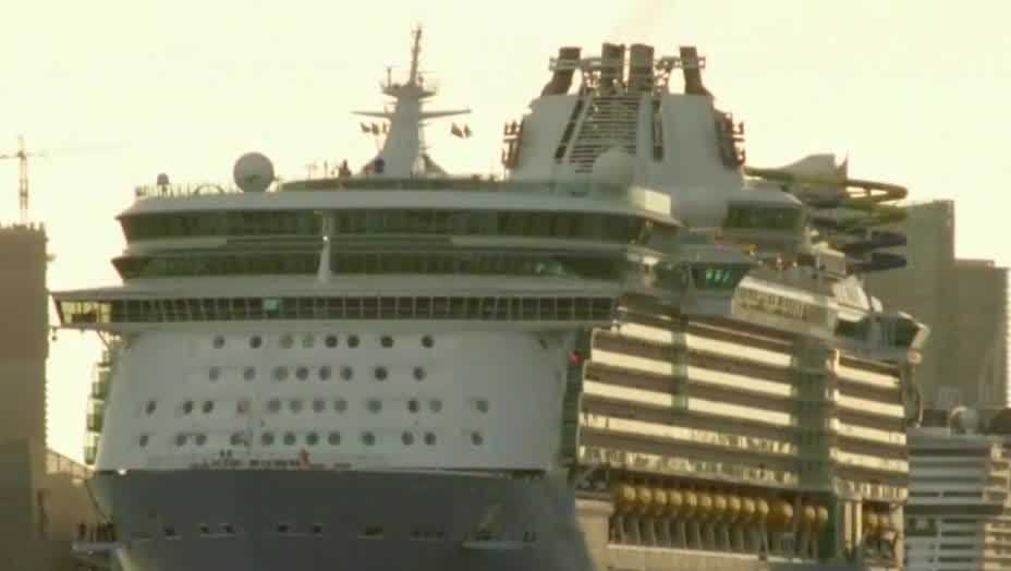 Passengers prepare to board Royal Caribbean's Allure of the Seas for 