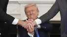 President Donald Trump, center, shakes hands with Armenian Prime Minister Nikol Pashinyan, right, and Azerbaijan President Ilham Aliyev during a trilateral signing ceremony in the State Dining Room of the White House, Friday, Aug. 8, 2025, in Washington. (AP Photo/Mark Schiefelbein)