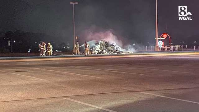Burning pile of trash dumped in store parking lot - Vimarsana News
