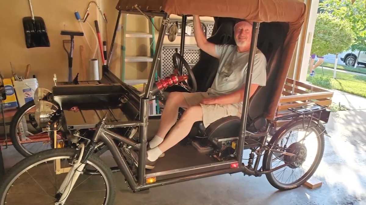 An inventor finished building a car using random yard sale items during