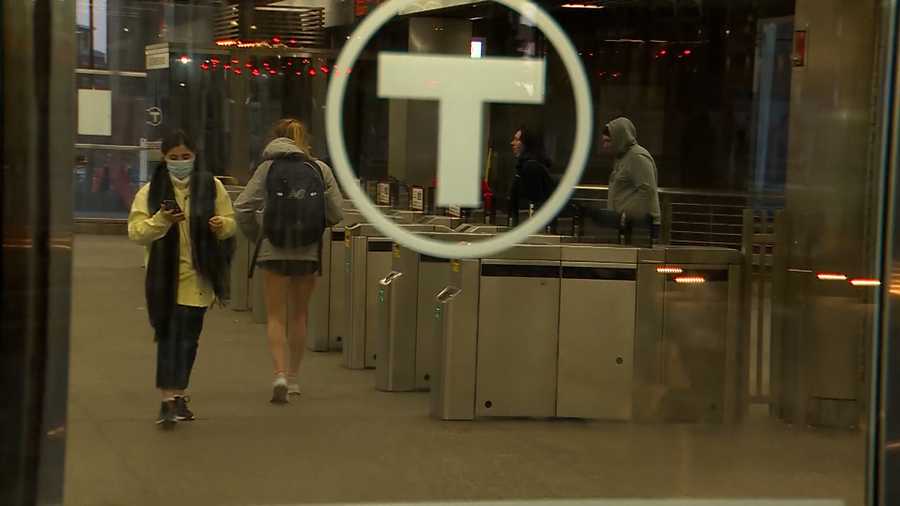 Some people chose to wear masks and others did not while traveling through MBTA stations in Boston, Massachusetts, on April 19, 2022, when the transit authority dropped its mask requirement.