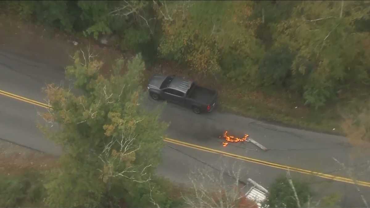 2 men trapped in truck by burning live wires after Milford crash