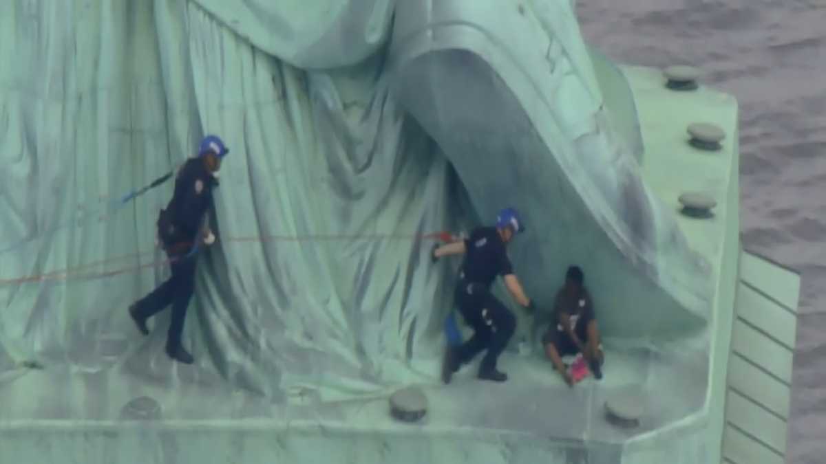 Watch final moments when police capture woman climbing Statue of Liberty
