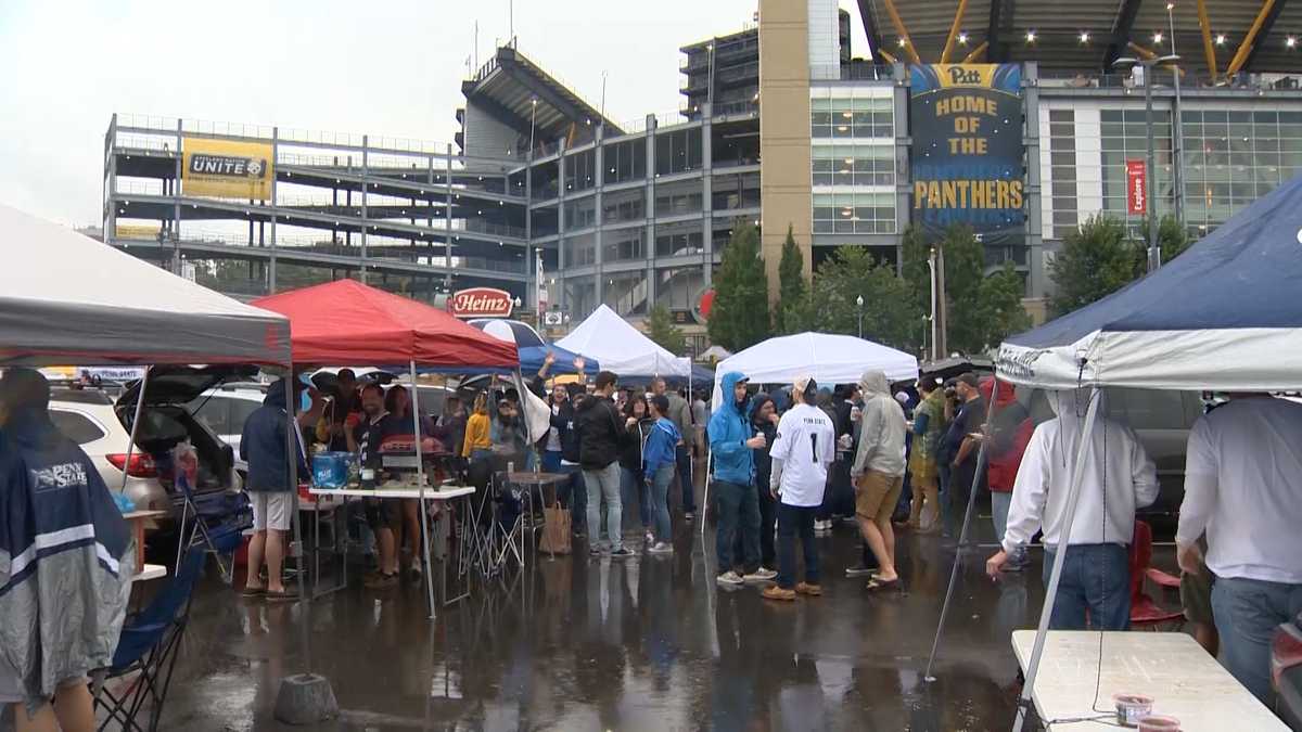 Pitt and Penn State fans tailgate in the rain before final rivalry game