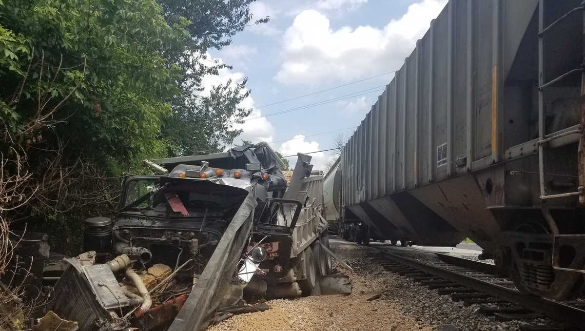 Two people hurt in collision involving train, dump truck