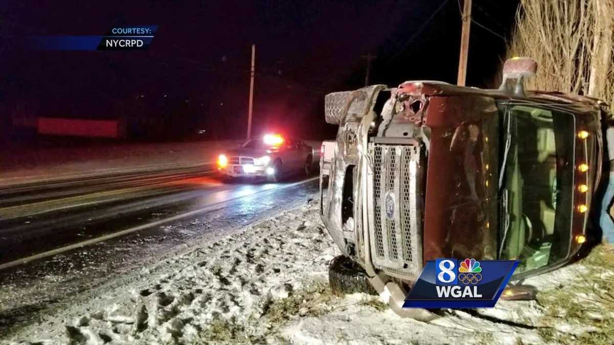 Truck flips on snowy road